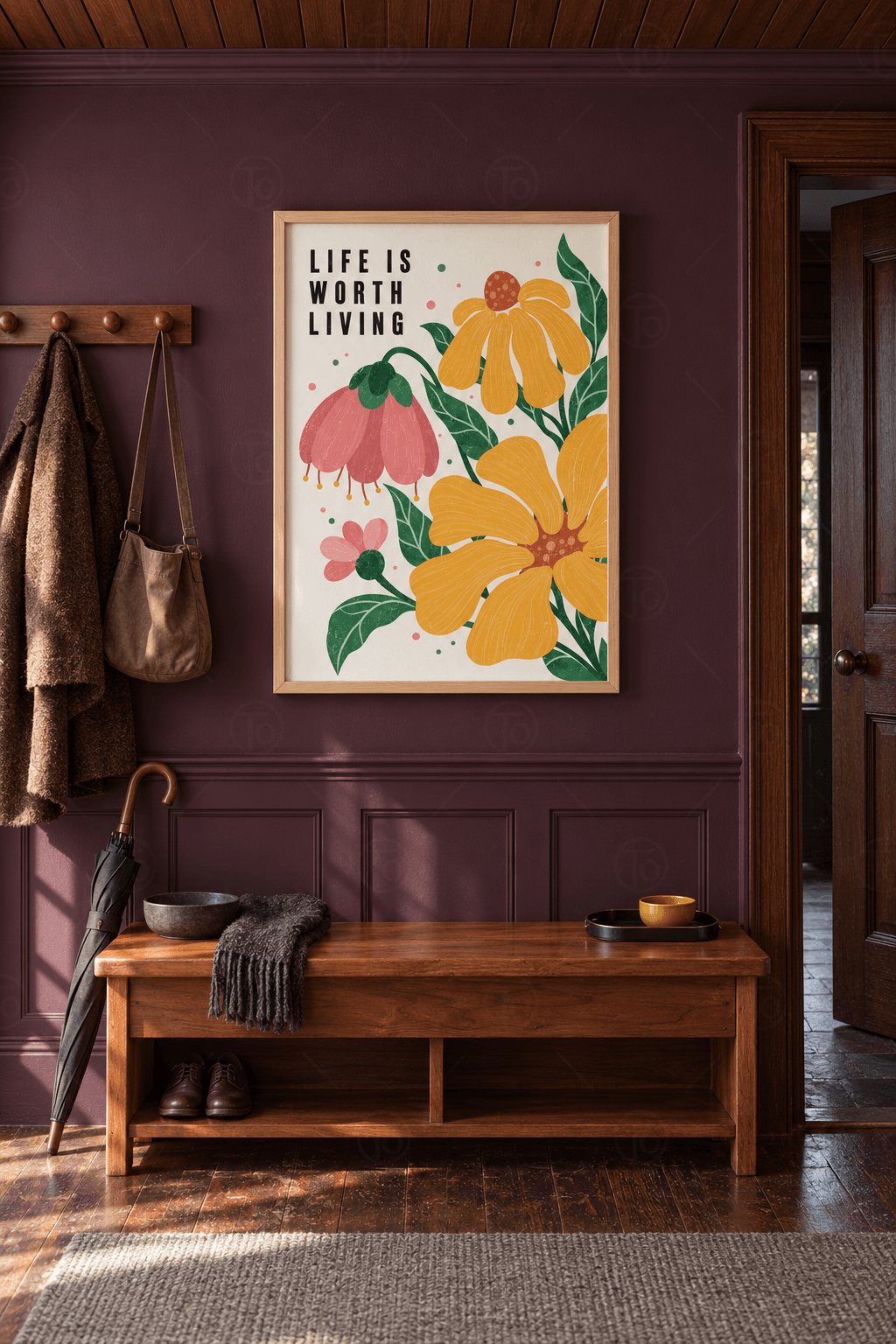 Ahşap çerçeveli yazılı tablo — krem zeminde siyah LIFE IS WORTH LIVING yazısı, sarı ve pembe çiçekler, yeşil yapraklar